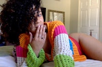 a woman with curly hair laying on a bed