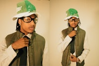 a man wearing glasses and a green hat