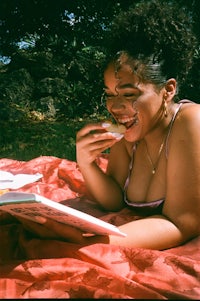 a woman in a bikini reading a book