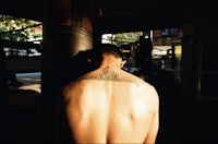 the back of a man with a tattoo