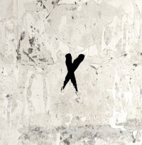 a black and white image of the letter x on a concrete wall