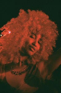 a woman with a red afro in a club