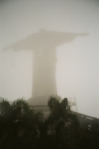 a statue of christ in the fog