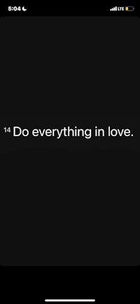 a black screen with a quote that says do everything in love